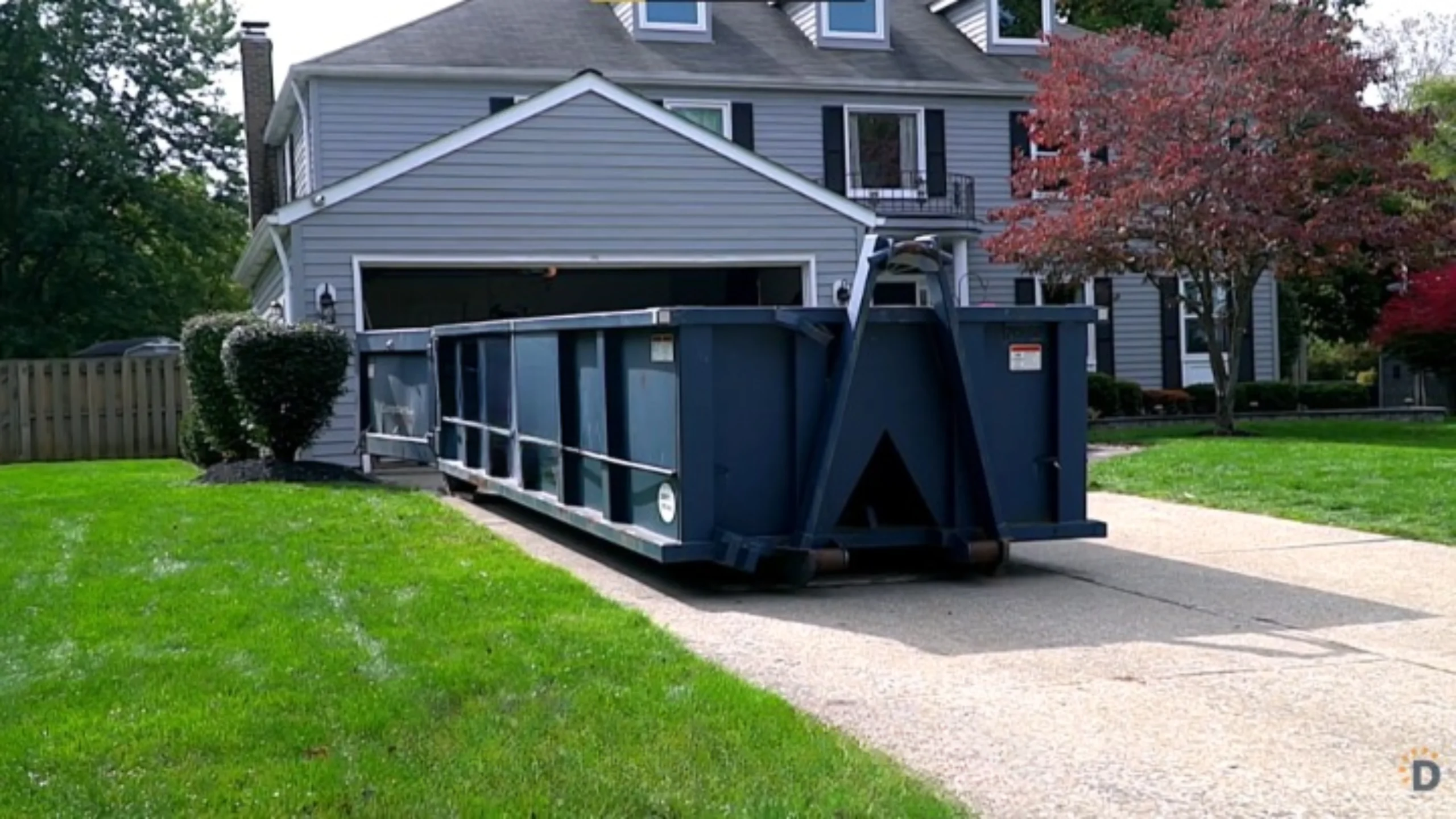 Dumpster being picked up after cleanup job in Daviess County