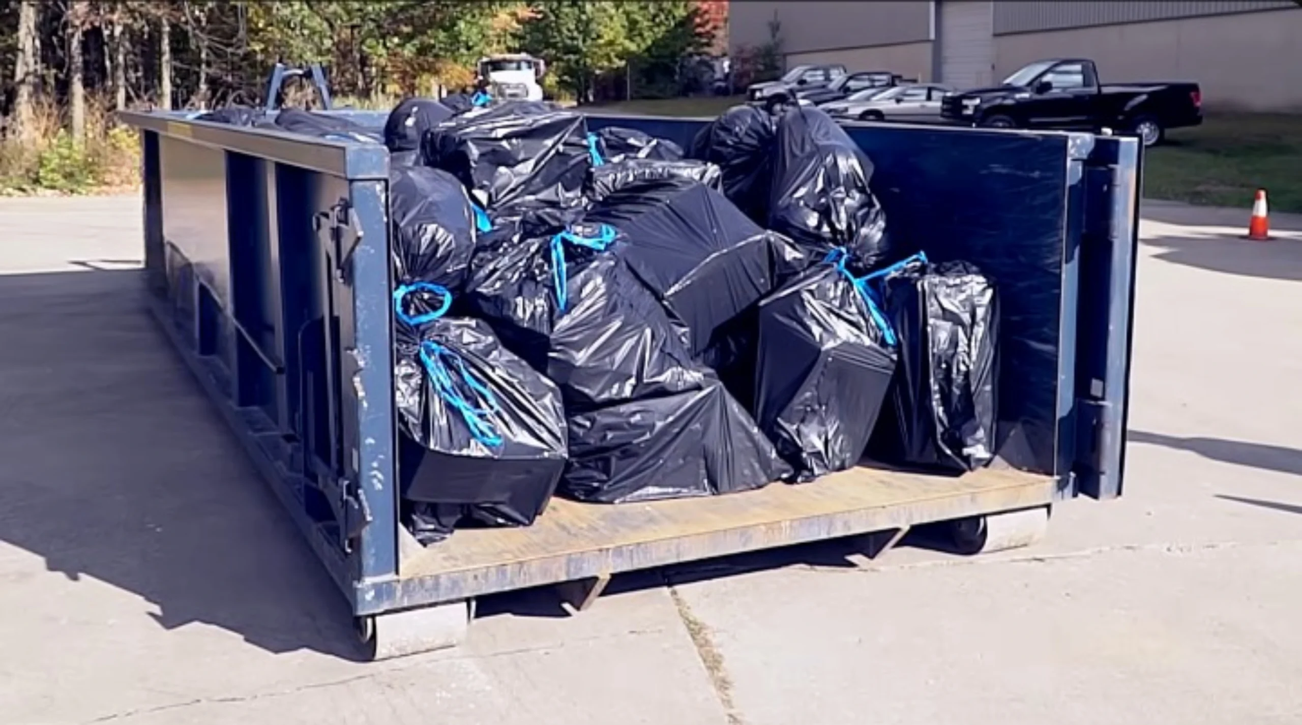 Roll off dumpster loaded with debris during a cleanup project