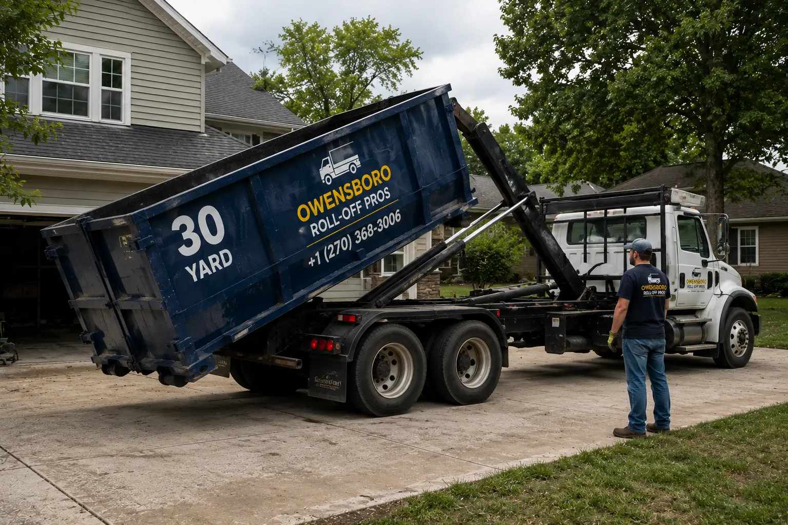 Dumpster delivery truck placing a 30 yard roll off container in a driveway in Owensboro, KY