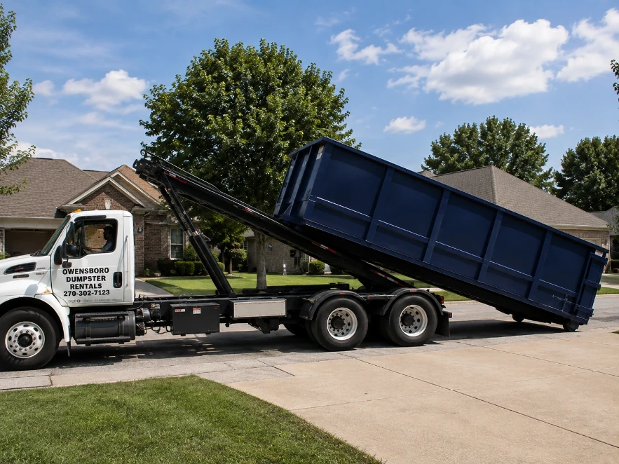 Roll off dumpster truck delivering to a driveway near Owensboro, KY